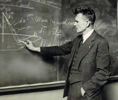 M. King Hubbert in front of a blackboard